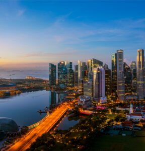 Singapore city and sunrise sky in harbour side view of hotel windows