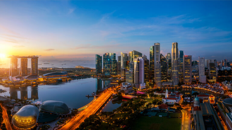 Singapore city and sunrise sky in harbour side view of hotel windows